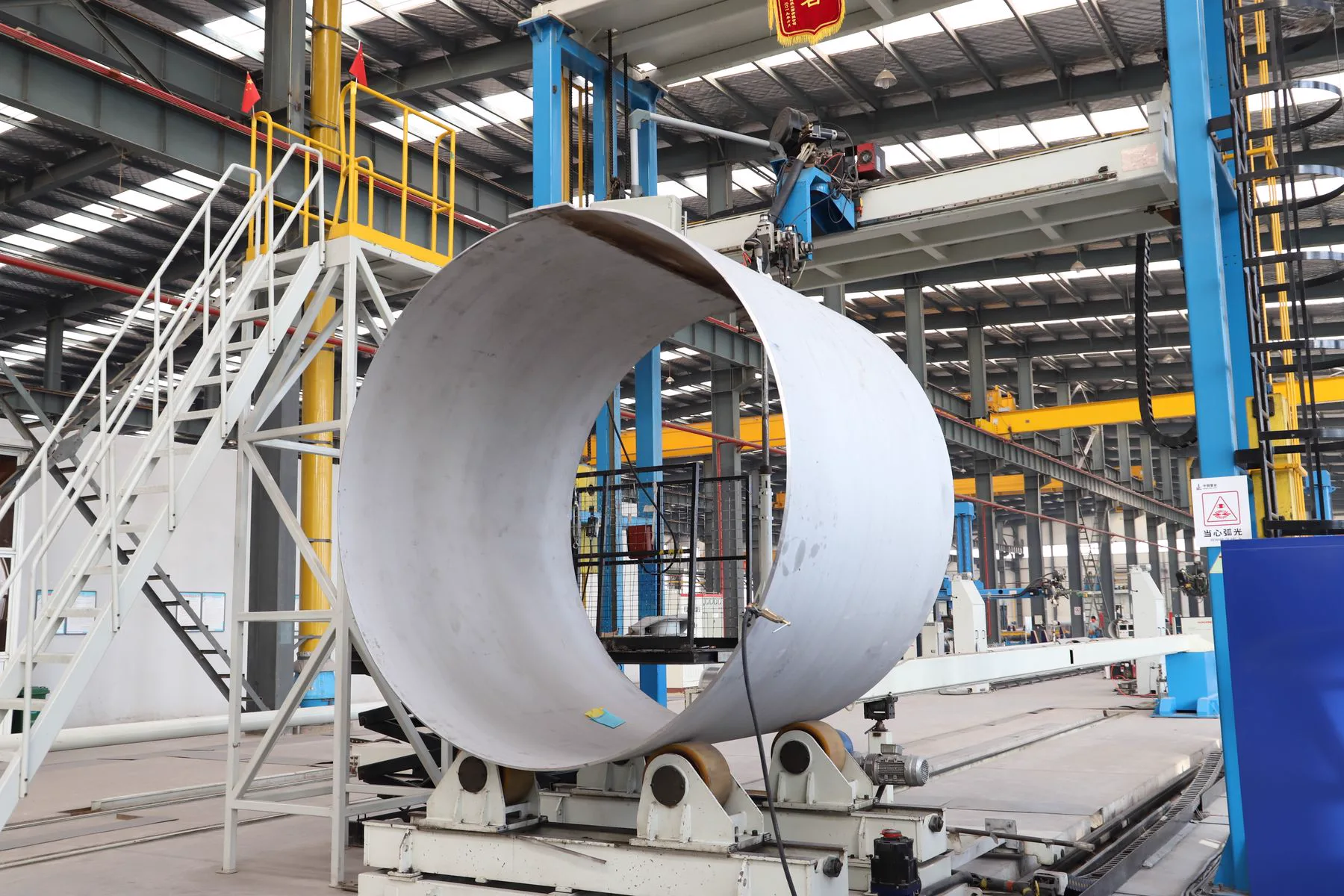 Steel strip being formed into tube after coil slitting